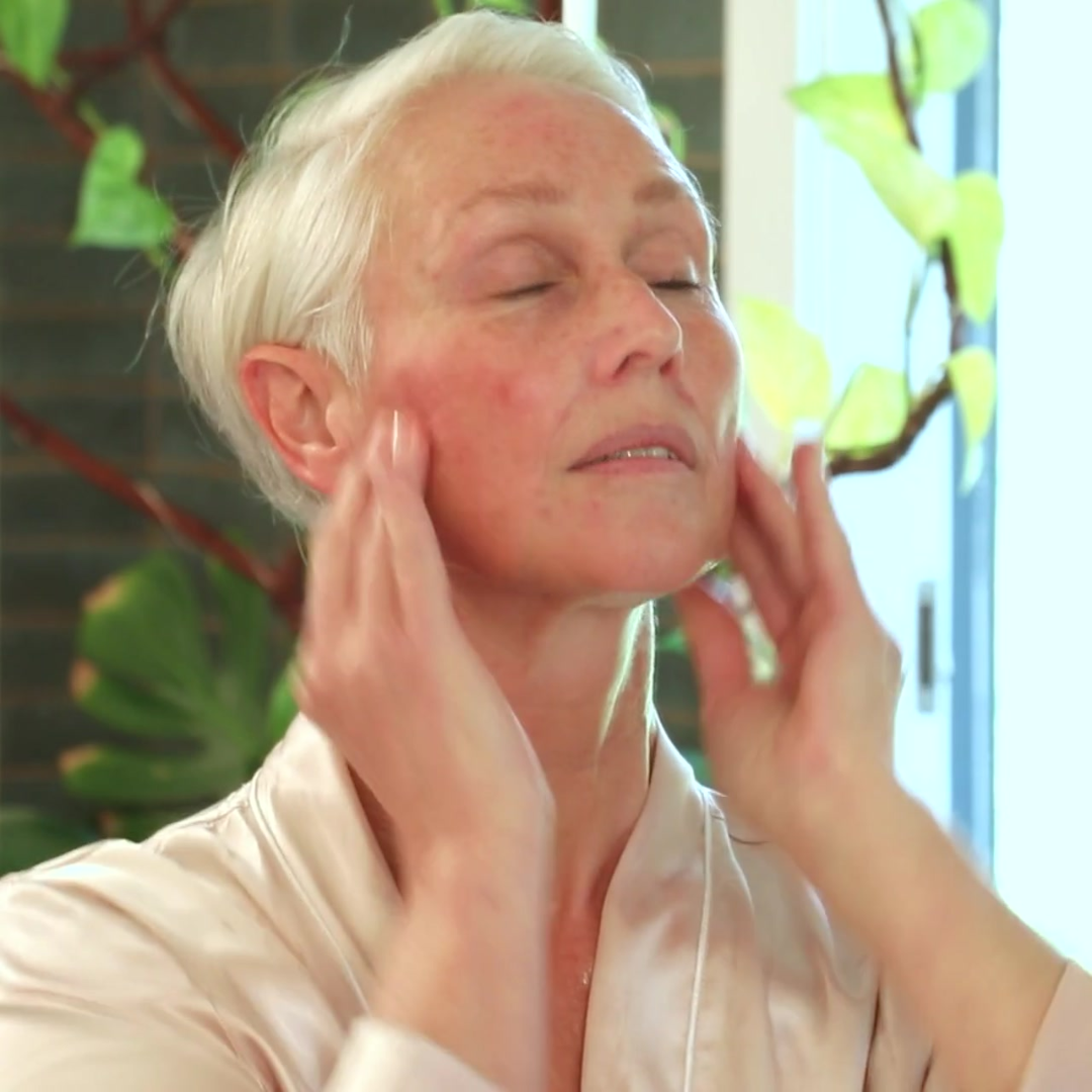 Philogeni founder, Barbara Marengo, applying the M-Veil Antioxidant Serum to her face 