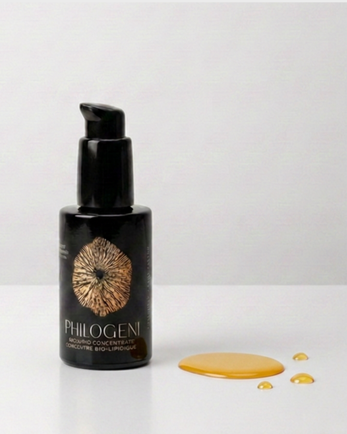 The Philogeni Antioxidant Serum bottle with oil pooled beside it