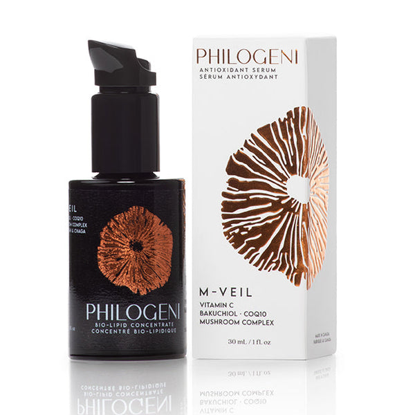 Image showing Philogeni M-Veil Antioxidant serum in miron glass packaging alongside the outer box showing copper foil emboss of spore-print logo for Philogeni